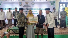 Bupati Rembang, H. Harno (kiri)  menyerahkan bantuan rumah layak huni dan modal usaha kepada para  mustahik di Masjid Agung Rembang, Selasa (27/5/2025).