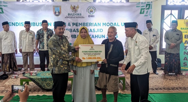 Bupati Rembang, H. Harno (kiri)  menyerahkan bantuan rumah layak huni dan modal usaha kepada para  mustahik di Masjid Agung Rembang, Selasa (27/5/2025).