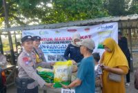Anggota Polres Demak sedang melayani masyarakat yang akan membeli beras murah dalam Gerakan Pangan Murah yang digelar Polres Demak.