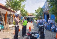 Anggota Satlantas Polres Demak sedang mensosialisasikan tertib berlalu lintas dan pelatihan safety riding di SMK Negeri 1 Demak, Senin (15/9/2025).