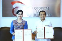 Pejabat Sementara Wakil Ketua Dewan Komisioner OJK, Friderica Widyasari Dewi dan Kepala Bareskrim Polri, Komisaris Jenderal Polisi Syahardiantono, usai menandatangsni PKS tentang Sinergisitas di Bidang Penegakan Hukum dan Koordinasi dalam Penanganan Tindak Pidana di Sektor Jasa Keuangan di Jakarta, Selasa (3/3/2026).