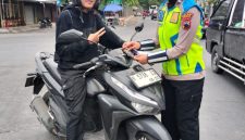 Anggota Satlantas Polres Demak menyosialisasikan Operasi Patuh Candi 2026 dengan membagikan pamflet kepada pengguna kendaraan,  Selasa (28/10/2026).