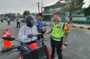 Anggota Satlantas Polres Demak mensosialisasikan tertib berlalu lintas dan pembayaran pajak kendaraan bermotor di kawasan Alun-alun Demak, Jum'at (30/10/2026).